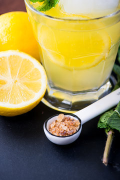 Refreshing lemonade with fresh citrus , mint and ice in glass