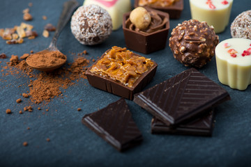 selection of artisan chocolates praline on black background