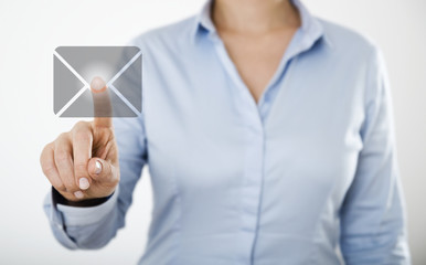 Businesswoman pressing e-mail icon on digital touch screen