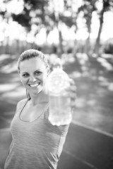 female athlete holding a water bottle