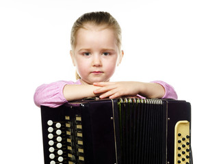 Cute little girl playing harmonica, music education concept