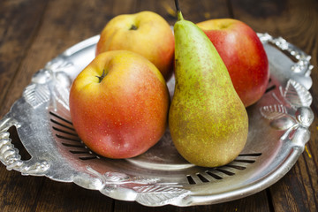 Naklejka na ściany i meble apples and pear on an tray