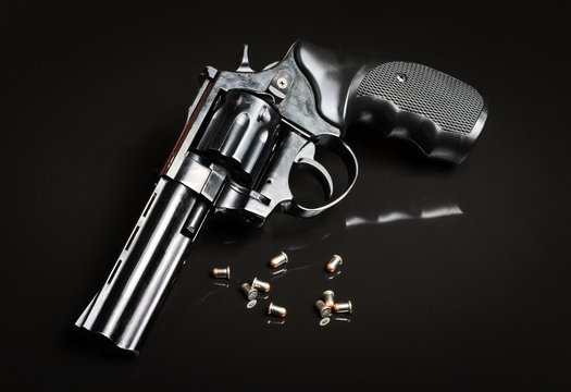 Revolver gun on black background
