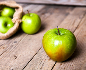 fruit. Ripe green apples on wooden background