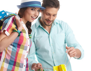 Young, smiling couple on a shopping spree. Shallow DOF, focus on