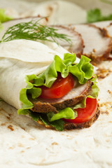 roll with meat and salad in pita bread