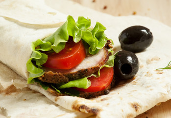 meat, salad and tomatoes in pita bread