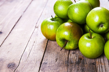 fruit. Ripe green apples on wooden background