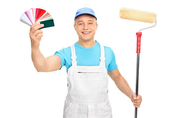 Painter holding a paint roller and color guide