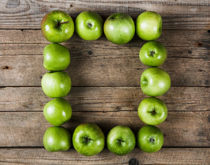 Ripe green apples on wooden background. fruit frame