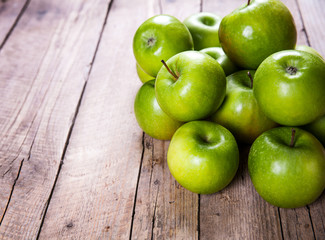 fruit. Ripe green apples on wooden background