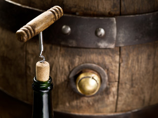Opening of a wine bottle with corkscrew.