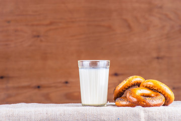 Cut loaf of fresh bread on burlap on wooden table