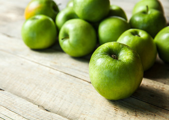 fruit. Ripe green apples on wooden background
