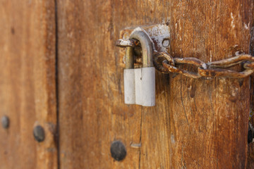 Old wooden gate with padlock