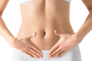 Woman holding hands on a belly. Stomach health concept. Isolated