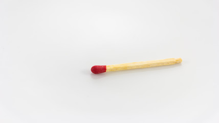 Close up of a red match on a white background