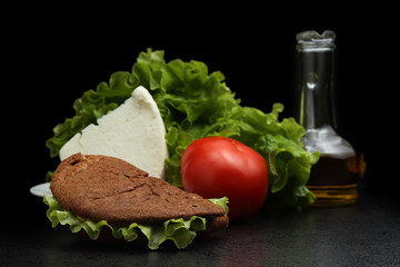 Vegetable and cheese sandwich. Tomato, salad leaves and olive oi