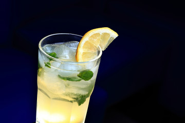 Glass of lemonade with a slice of lemon and mint