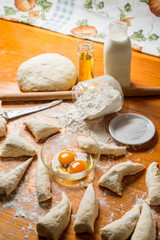 Fresh baked dough for bread or rolls and ingredients for cooking