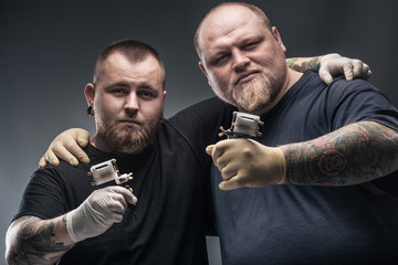 Two mans tattoo artists