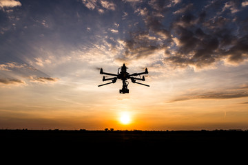 Fototapeta na wymiar Professional drone flying in the sunset