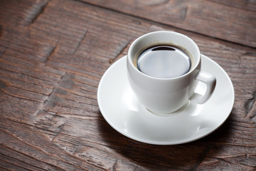 Coffee cup and saucer on wooden table