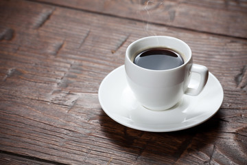 Coffee cup and saucer on wooden table