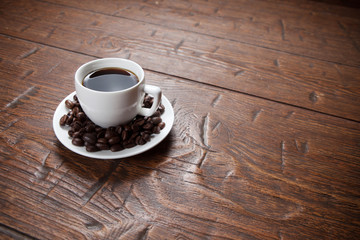 Coffee cup and saucer on wooden table