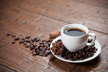 Cup of coffee with beans and spicery