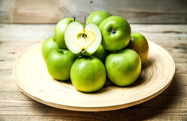 fruit. apples in a bowl on wooden background
