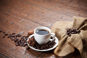 Cup of coffee with beans and spicery