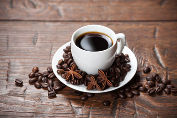 Cup of coffee with beans and spicery