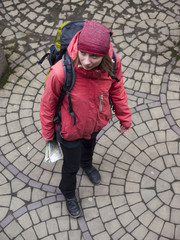 Girl with a backpack and a map.