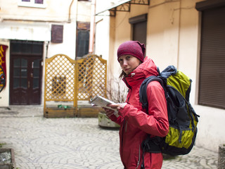 Girl with a backpack and a map.