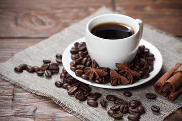 Cup of coffee with beans and spicery