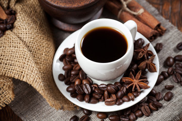 Cup of coffee with beans and spicery