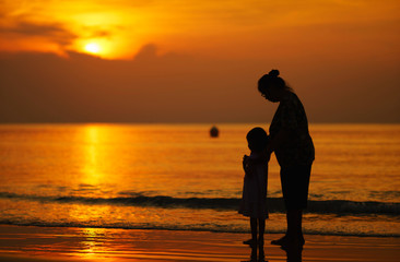 Mother and daughter watching the sunset