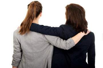 Two women embracing each other.
