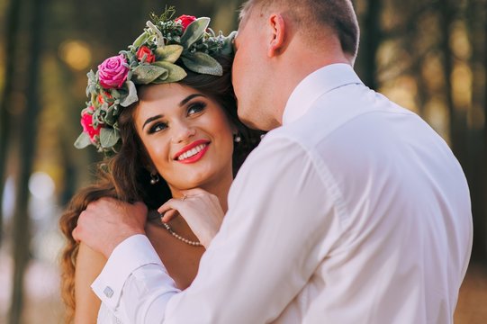 happy bride and groom walking in the autumn forest