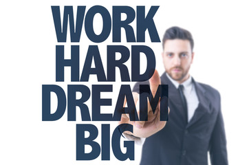 Business man pointing the text: Work Hard Dream Big