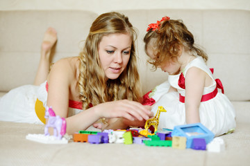Mother and daughter playing with blocks