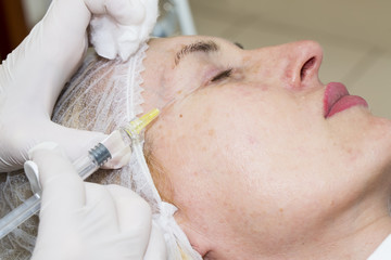 Cosmetic treatment with injection in a clinic