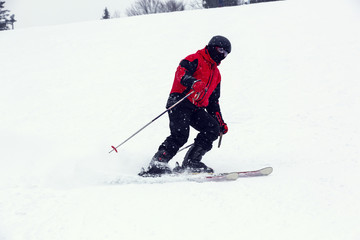 male skier on downhill a steep hill