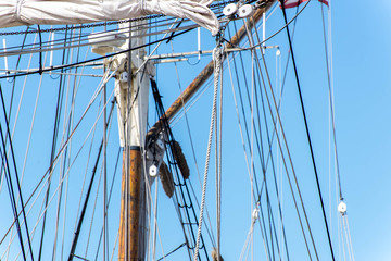 Fototapeta premium sailboat masts, rigging and rolled up sails