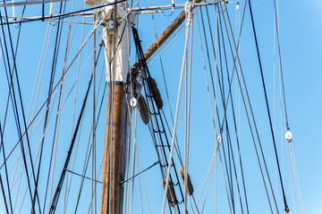 sailboat masts, rigging and rolled up sails