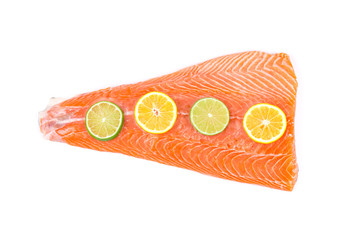 Red fish fillet with lemon slices.