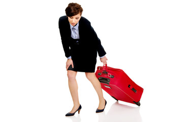 Tired businesswoman with suitcase.