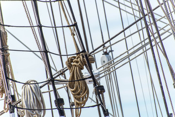 sailboat masts, rigging and rolled up sails