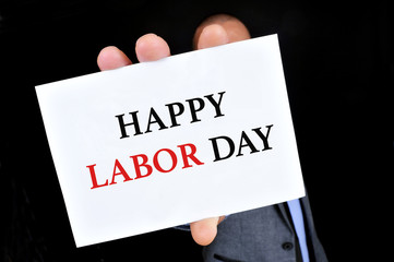 man showing a signboard with the text happy labor day